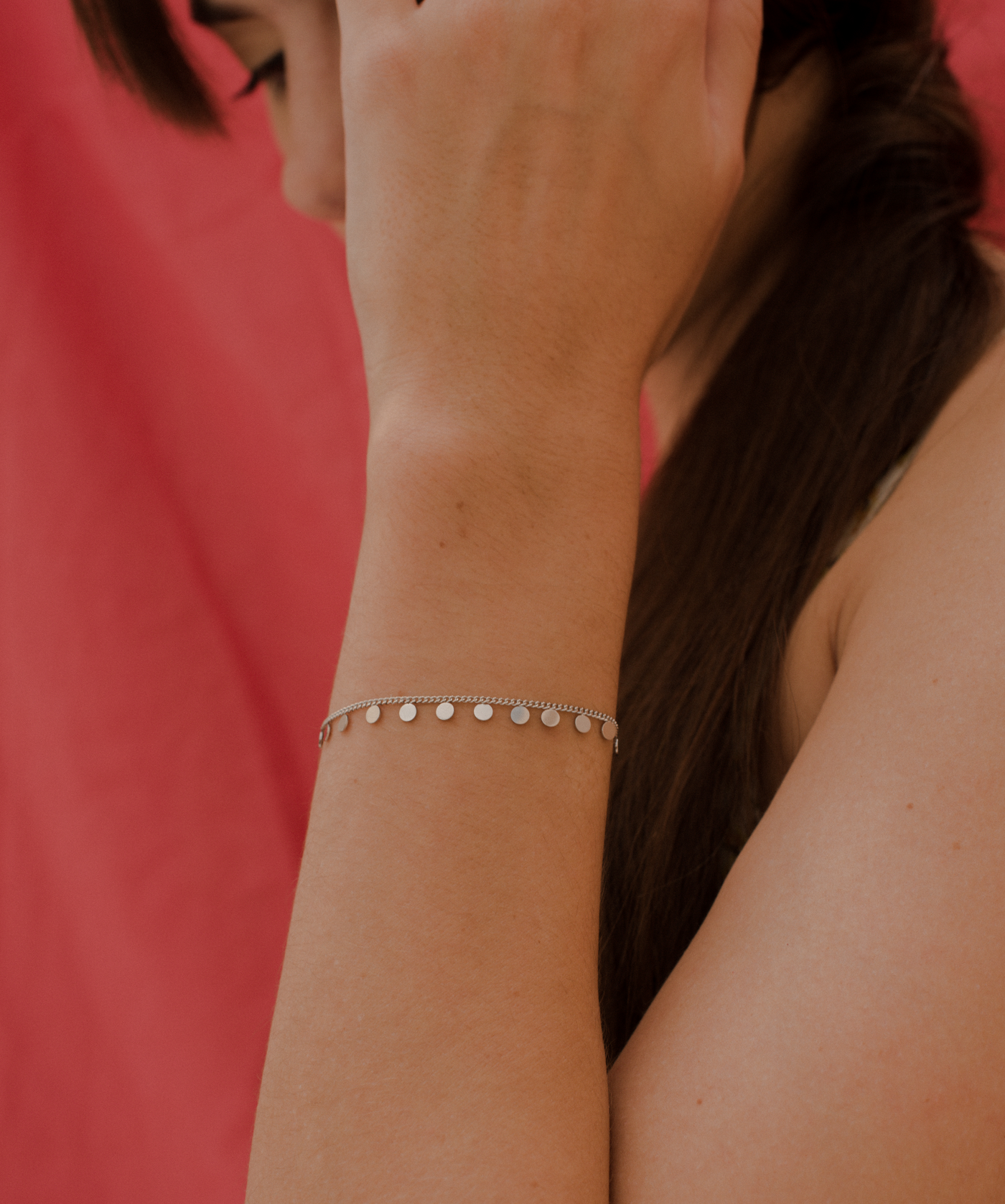 Frau trägt feminines Armband mit Plättchen Anhänger aus Edelstahl 