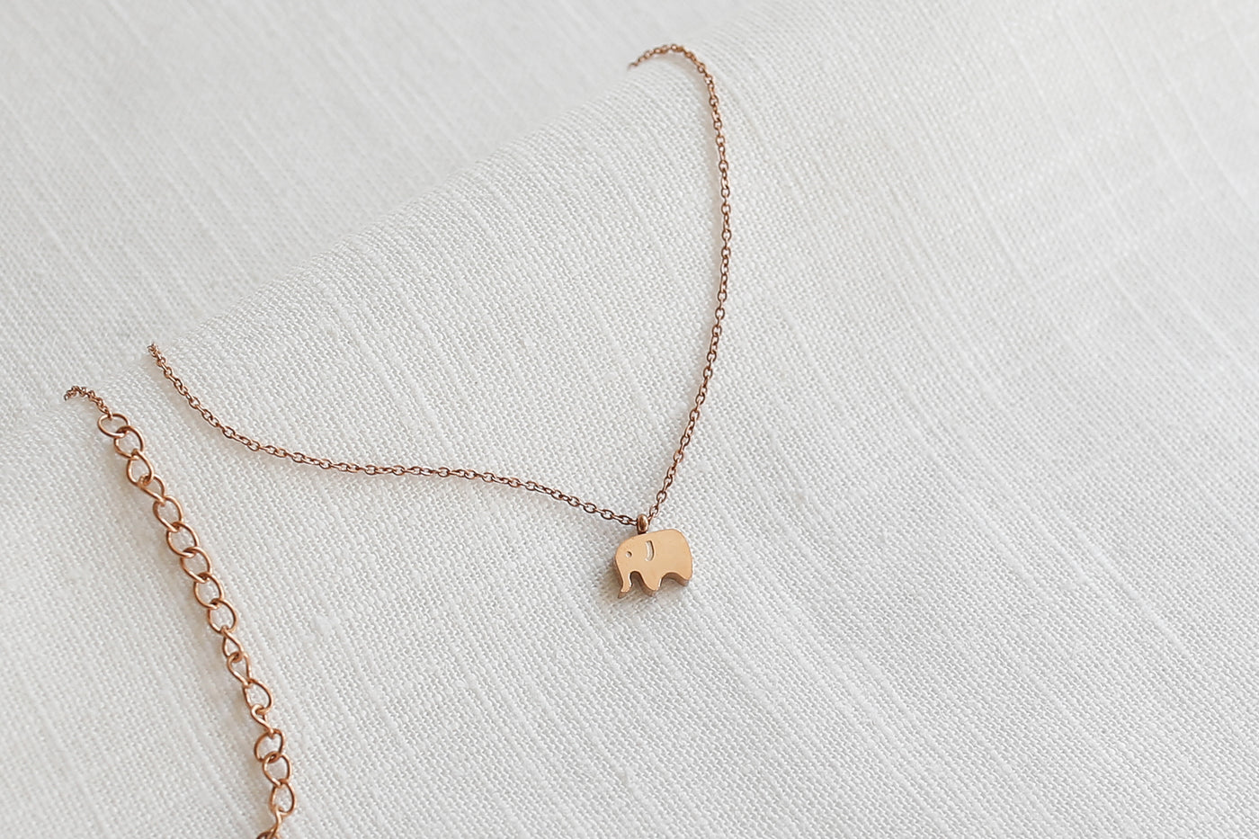 Minimalistische Halskette mit Elefant Anhänger und verlängerungs Verschluss in Rosegold auf Stoff