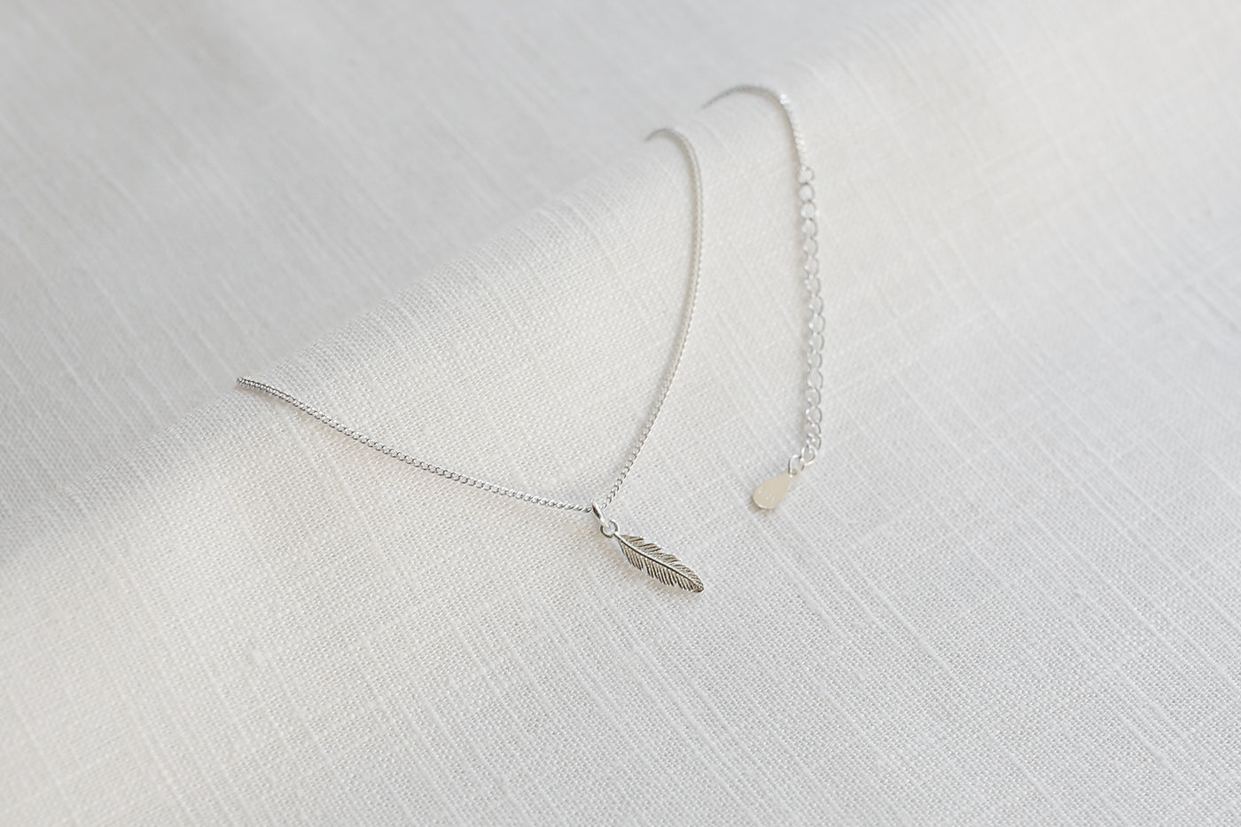 Sterling silver necklace with feather pendant and Happiness greeting card