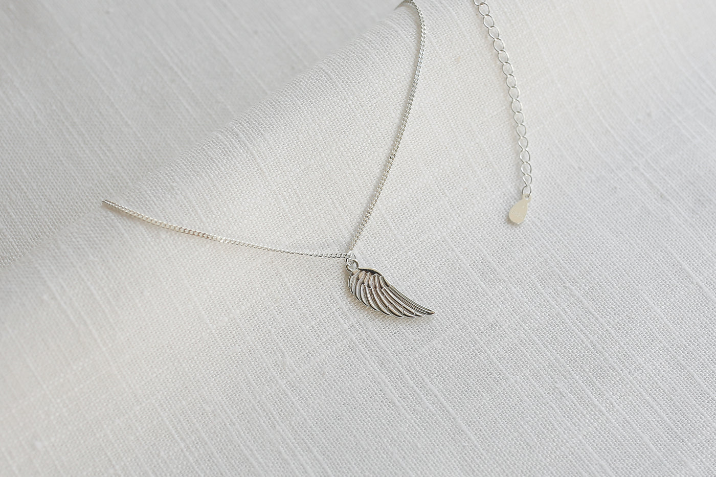 Sterling silver necklace with angel wing pendant and Happiness greeting card