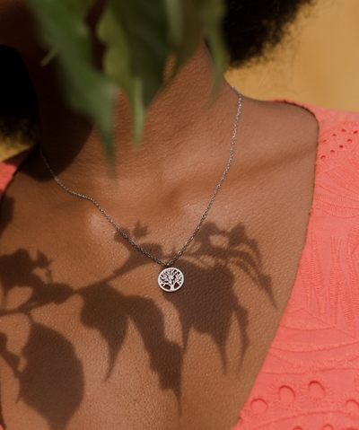 Junge Frau trägt minimalistische Halskette mit Lebensbaum Anhänger aus Edelstahl